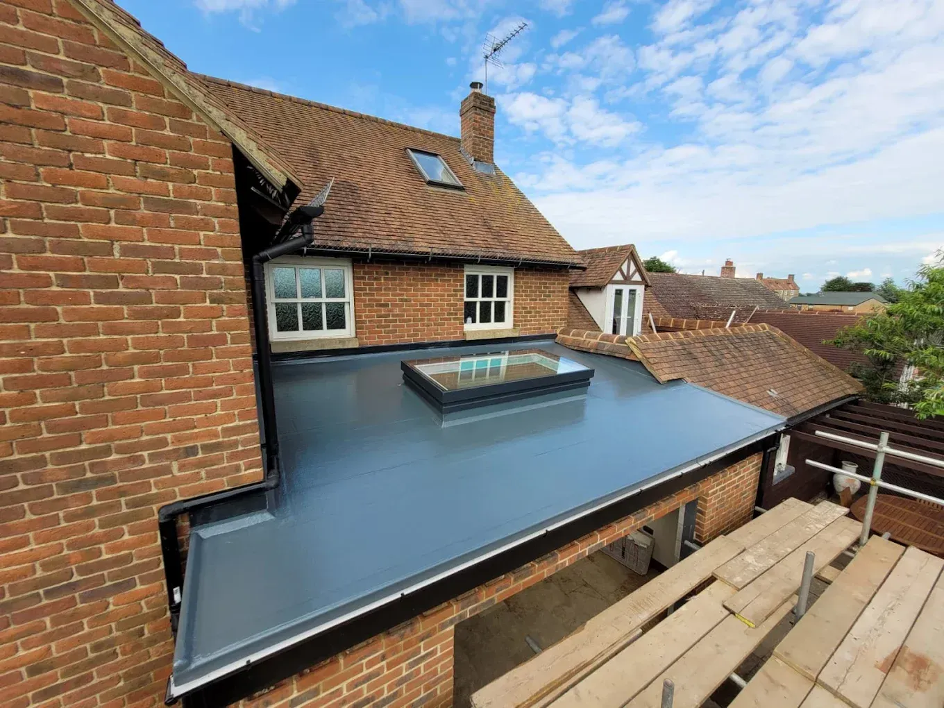 Newly installed modern grey flat roof with large rooflight in Oxfordshire.