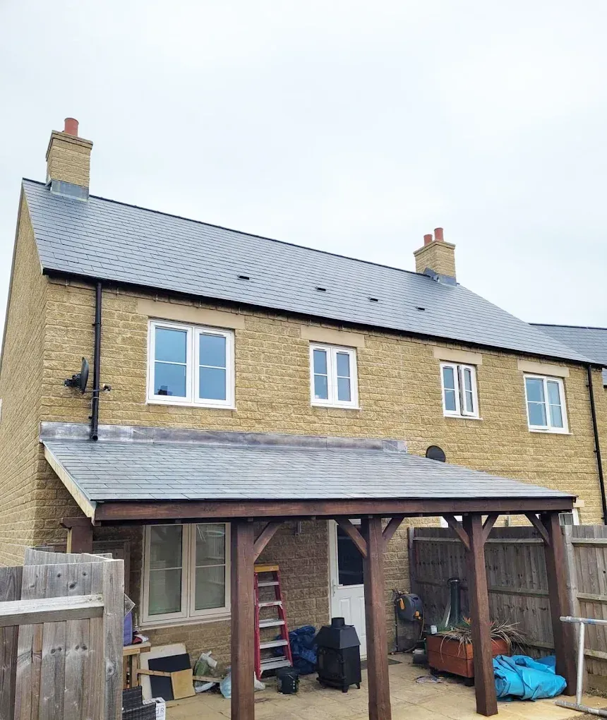 Newly completed slate pitched roof installation on a stone residential property by Ox Roofing Ltd