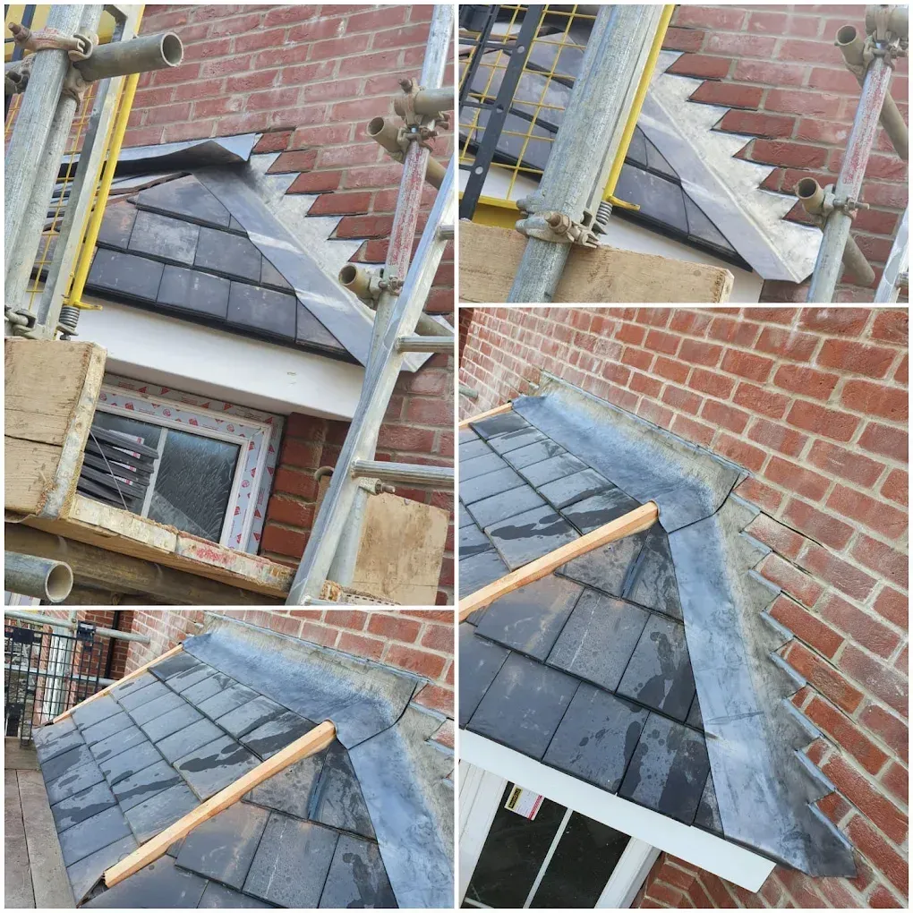 Small slate roof over a window with lead flashing dressed into the brickwork where the roof meets the wall